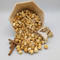 Iced Cinnamon Roll The Popcorn Loft flavored popcorn with white chocolate icing drizzle in golden caramel tones