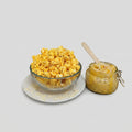 Mac and Cheese The Popcorn Loft cheese popcorn mix in golden yellow with shredded cheese on top